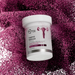 Microbiome Labs Vaginal Balance bottle on a textured pink background